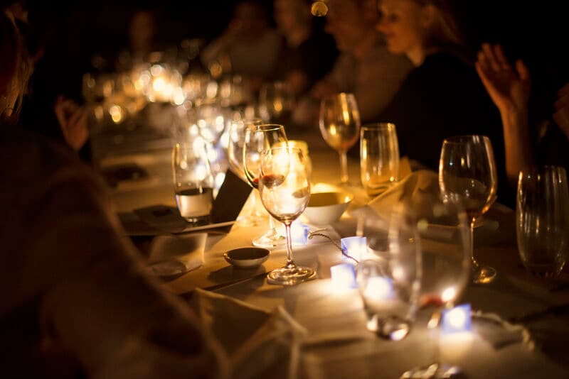 upscale event banquet table dinner by candlelight at night time