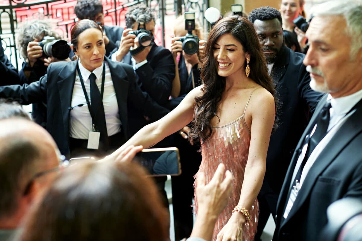 celebrity on red carpet protected by security agents celebrity on red carpet protected by security agents
