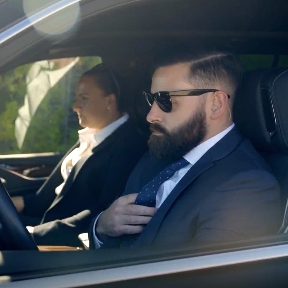 two personal protection agents driving and riding in a vehicle two personal protection agents driving and riding in a vehicle