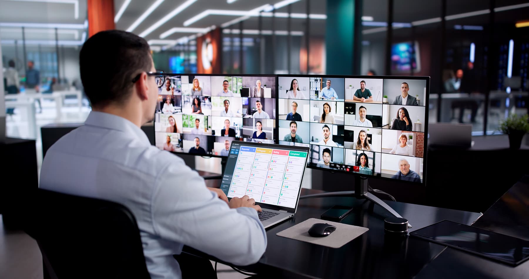 Employee at desk in a virtual team meeting Employee at desk in a virtual team meeting