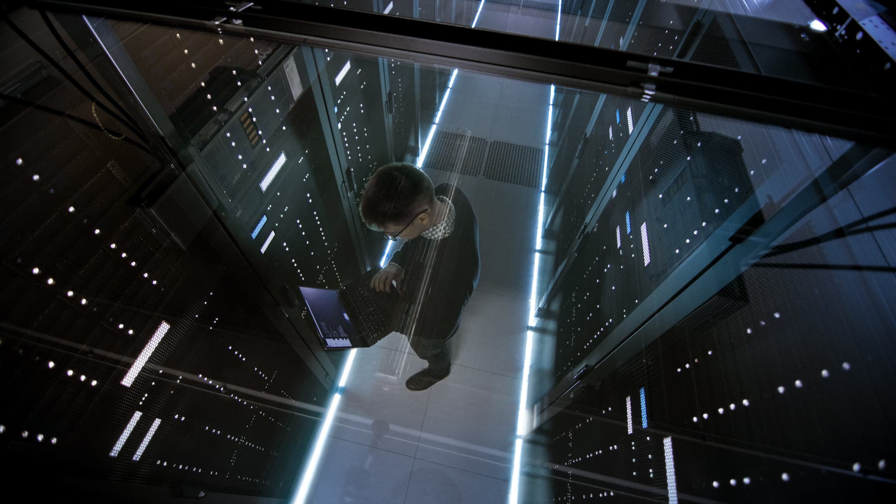 Man working in a highly technical server room Man working in a highly technical server room