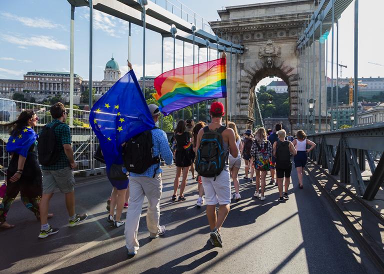 Citizens march through Budapest during a Gay Pride event to support LGBTQ rights.